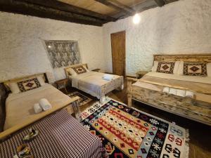 a room with two beds and a rug at Norral shelter 1 in Kajvall