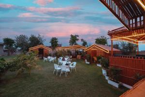 a group of white tables and chairs in a yard at Sambhariya Bagh Resort in Kānota