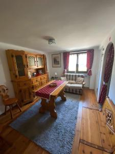 a living room with a table and a couch at A Casa di Zia Renny in Châtillon