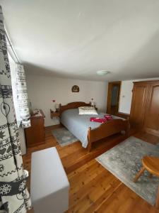 a bedroom with a bed and a wooden floor at A Casa di Zia Renny in Châtillon
