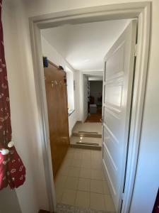 a hallway with a white refrigerator in a room at A Casa di Zia Renny in Châtillon