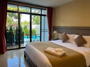 a bedroom with a large bed and a large window at Radateeree Boutique Resort in Chiang Mai +23 photos