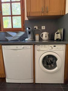 a kitchen with a dishwasher and a washing machine at Mas Ferrieres Saint Laurent in Saint-Laurent-le-Minier