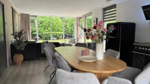 a living room with a wooden table and chairs at Huisje 47 | 8 persons in Gasselte