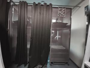 a bathroom with a shower curtain and a sink at Suvidha Dormitory Hotel in Bhuj +25 photos