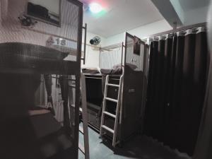 a room with a cage and a bunk bed at Suvidha Dormitory Hotel in Bhuj