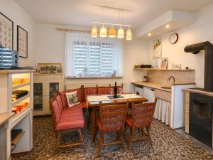 a kitchen with a table and chairs and a kitchen with a refrigerator at Kovárna Klapý pod Hazmburkem - České středohoří in Klapý