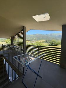 a glass table on a balcony with a view at Clusone - Dosso Cascì in Clusone