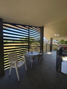 a balcony with a table and chairs and a window at Clusone - Dosso Cascì in Clusone