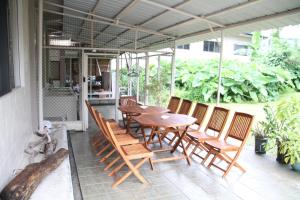 a wooden table and chairs on a patio at DW Motel in Koror