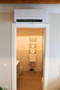 a bathroom with a toilet and a towel rack at Cà Dei Nonni in Castelfranco Veneto +50 photos
