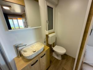 a bathroom with a sink and a toilet at Mobile homes Camp Kozica in Sibinj Krmpotski +39 photos