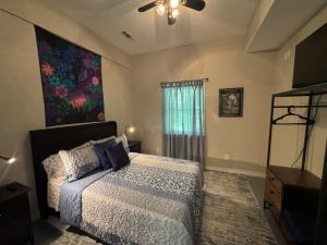 a bedroom with a bed and a ceiling fan at Peace in the Holler in Eureka Springs
