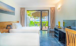 a hotel room with two beds and a view of the ocean at Temple Beach Resort in Danang
