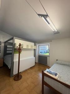 a bedroom with a bed and a cross on the floor at Clusone - Dosso Cascì in Clusone