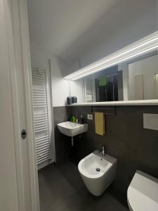 a bathroom with a white sink and a toilet at Clusone - Dosso Cascì in Clusone +10 photos
