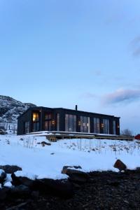 a house in the snow at dusk at Fredvang Lodge, Lofoten in Fredvang