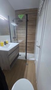 a bathroom with a white toilet and a sink at The Simpsons in Seville in Mairena del Aljarafe