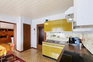 a kitchen with yellow cabinets and a counter top at Landidylle – Nostalgie in Ortenberg
