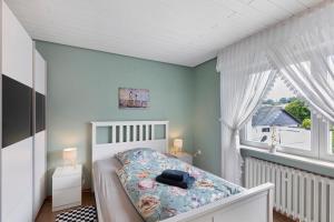 a small bedroom with a bed and a window at Landidylle – Nostalgie in Ortenberg