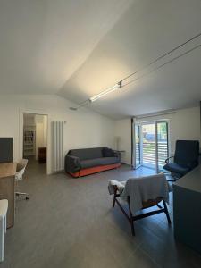 a living room with a bed and a couch and chairs at Clusone - Dosso Cascì in Clusone