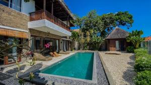 a swimming pool in the backyard of a house at Villa Dew Canggu in Kerobokan