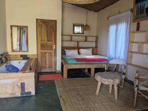 a bedroom with a bed and a tub in it at Giraffe Gallery Home in Arusha