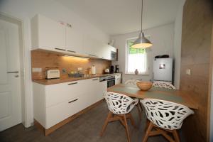 a kitchen with a wooden table and two chairs at Zum Notar in Brand-Erbisdorf