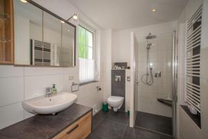 a white bathroom with a sink and a toilet at Zum Notar in Brand-Erbisdorf
