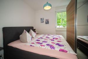 a bedroom with a bed with a pink and white comforter at Zum Notar in Brand-Erbisdorf +16 photos