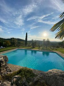 a swimming pool with a view of the mountains at Colombaio di Cencio in Gaiole in Chianti