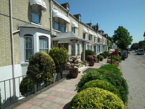 a row of houses on a street with bushes at Centennial Hotel in Cambridge