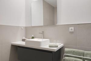 a bathroom with a white sink and a mirror at Bij Oriënshuis in Varsseveld +17 photos
