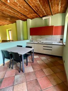 a kitchen with a table and chairs in a room at Sosta dei Passeggeri in Roccabruna +1 photo