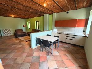 a kitchen with a table and chairs in a room at Sosta dei Passeggeri in Roccabruna