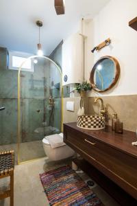 a bathroom with a toilet and a shower with a mirror at Tembo Apartment in Sinj +15 photos