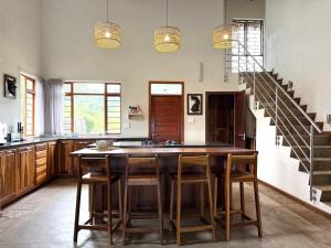 a kitchen with a large wooden island with stools at The Sanctuary- Self Catering Accommodation in Nelspruit