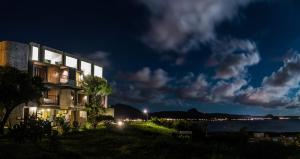 a building with a view of the water at night at The Light in Hengchun South Gate