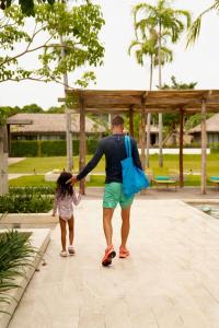 a man and a little girl walking down a sidewalk at JATI Koh Russey in Sihanoukville +134 photos