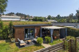 a tiny house in a garden with a tent at Bruval Eco Retreat in Sandim