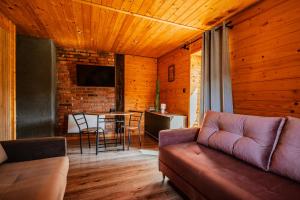 a living room with a couch and a table at Stachowa Chata Guciów in Guciów