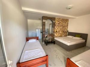 a bedroom with two beds and a mirror at Apartmani Ličina in Bečići