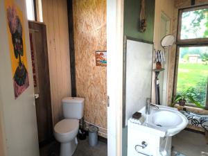 a bathroom with a toilet and a sink at Barn Suite in Valga