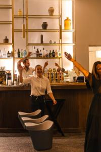 a man and a woman standing in front of a bar at Negrecoste Hôtel & Spa in Aix-en-Provence
