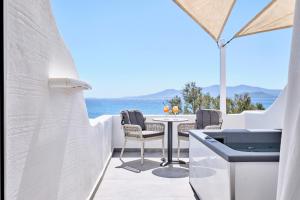a patio with a table and chairs and the ocean at Liana Beach Hotel & Spa in Agios Prokopios +83 photos