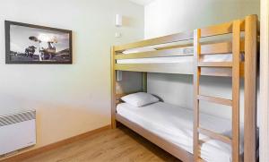 a bunk bed room with a bunk bed with a ladder at Résidence Vacancéole Les Chalets d'Ax in Ax-les-Thermes +40 photos