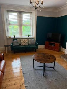 a living room with a couch and a coffee table at 4, The Croft, Bellingham in Bellingham