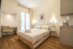 a bedroom with a large bed and a window at Syntagma Gem 1 in Athens