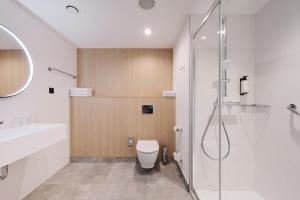 a bathroom with a toilet and a shower at Première Classe Warsaw Airport in Warsaw +22 photos