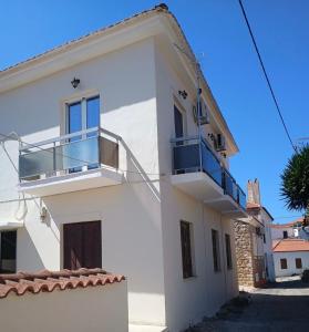 a white house with a balcony on the side at Methoni Joanna House in Methoni
